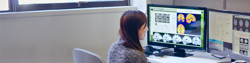 woman staring at screen of brain scans